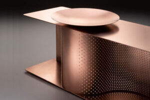 A copper shoe bench with sinuous sense of movement